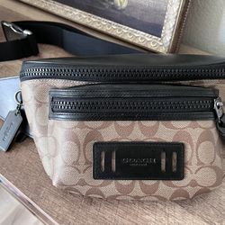 This is a Coach Terrain Belt Bag in signature canvas and black refined calf leather. 