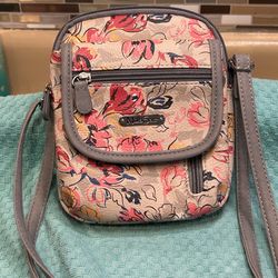 NEW! MultiSac Mini Everest Crossbody Bag featuring a colorful floral pattern and multiple zippered compartments. Design: A compact, rectangular crossb