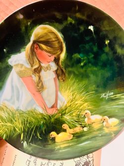 This is a 1984 Donald Zolan "Golden Moment" collector plate from the Children and Pets collection.