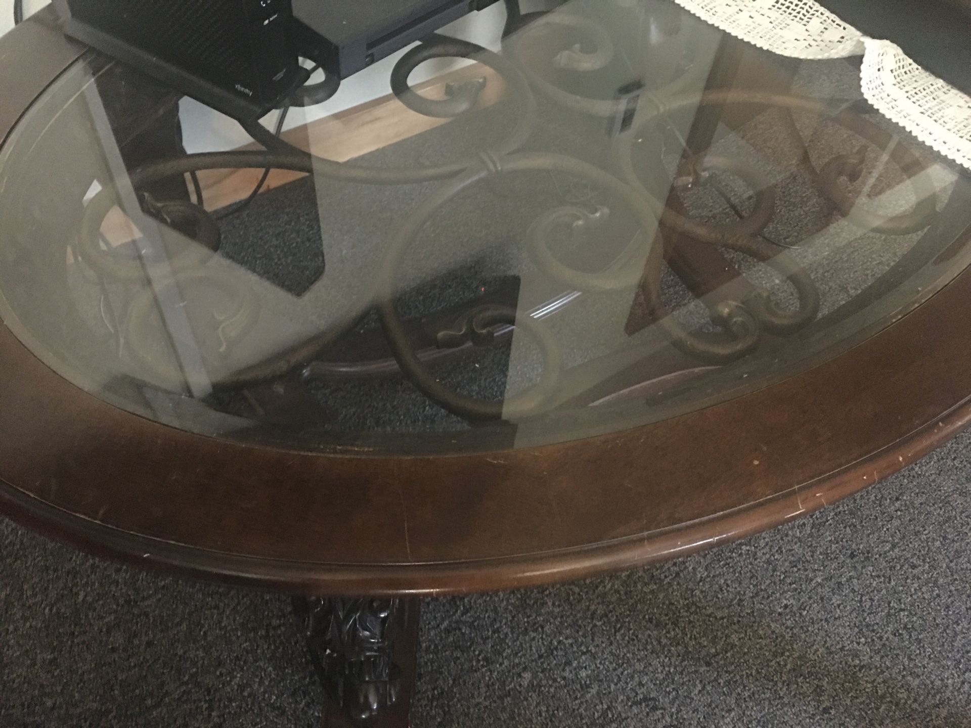 Small Wooden table with glass top.