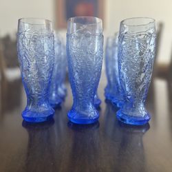 12 Vintage Blue Glasses 6.5 Inch High With Grapevine Raised Design From Top Tapering To Glass Bottom 