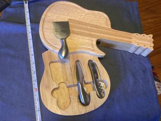 This guitar-shaped cheese board by Picnic Time features a split level cutting board that swivels open to reveal a corkscrew and two cheese tools (one 