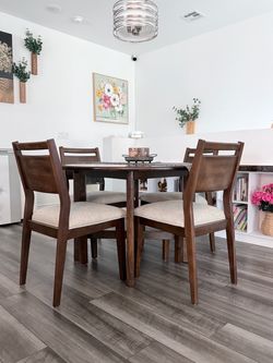 Beautiful 5-piece dining set with one round table and four upholstered chairs.