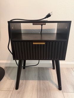 Black bedroom side table with outlet