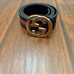 Clean black designer-inspired crossbody bag in excellent condition.  Features: 	•	Classic GG-style pattern throughout 	•	Adjustable red & blue stripe 