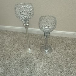 A Pair Of Silver Finish Glass Candles