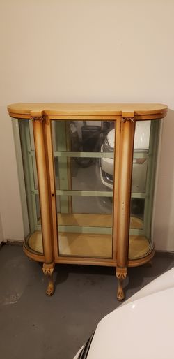 Antique curved glass china cabinet with locking door.