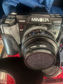 Minolta 7000 Camera Set Includes Minolta 7000 camera, flash, manuals, and accessories.