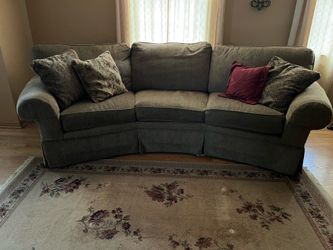 Curved couch and 2 chairs.