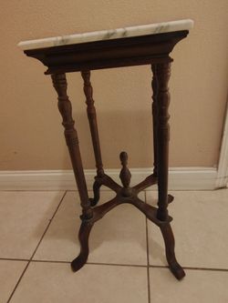 Corner table with marble top.
