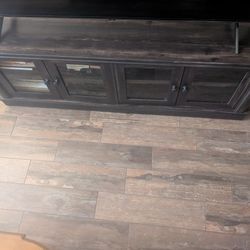 Tv stand with glass storage drawers on the bottom