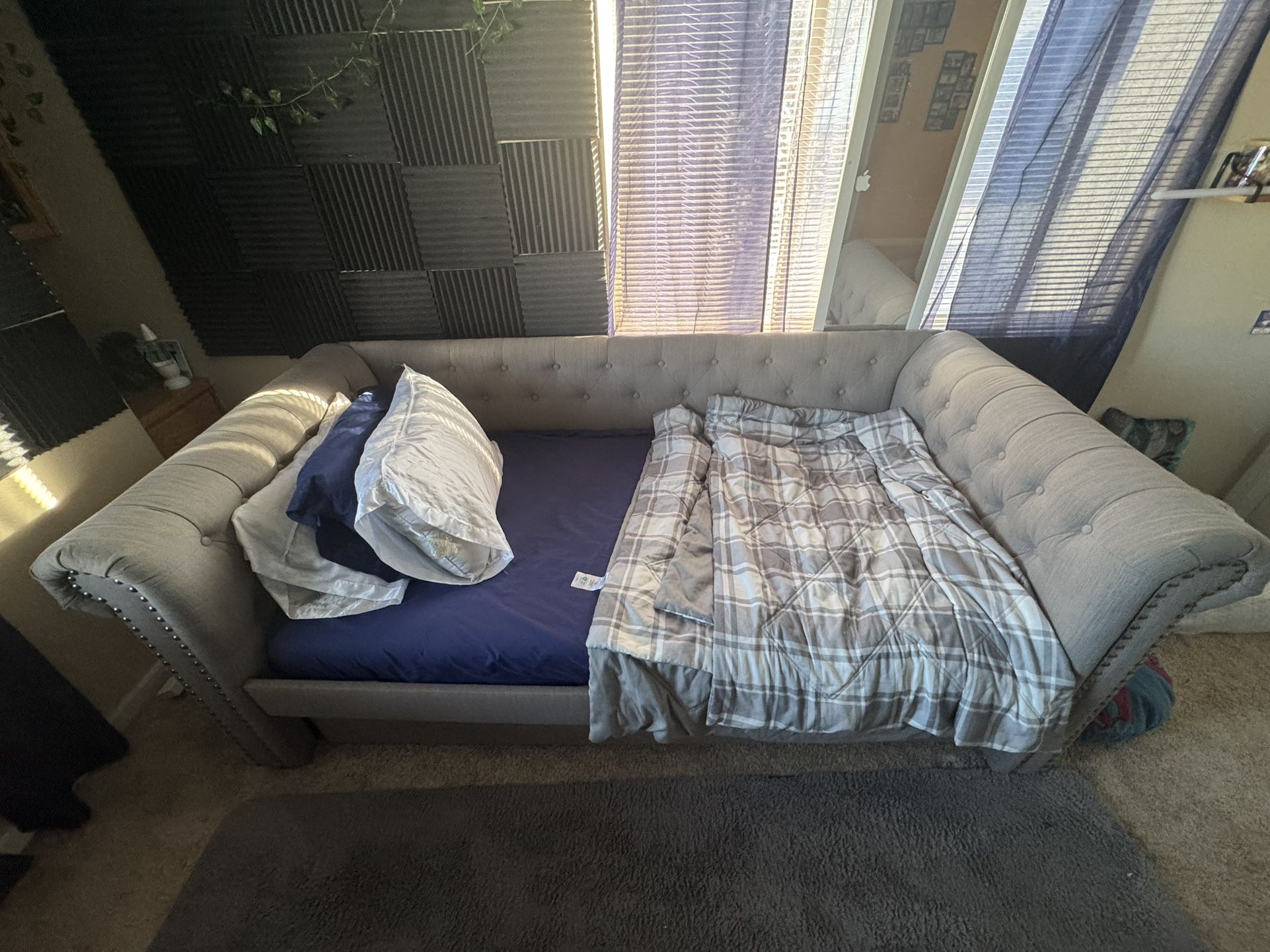 Bed with another bed underneath like a bunk bed