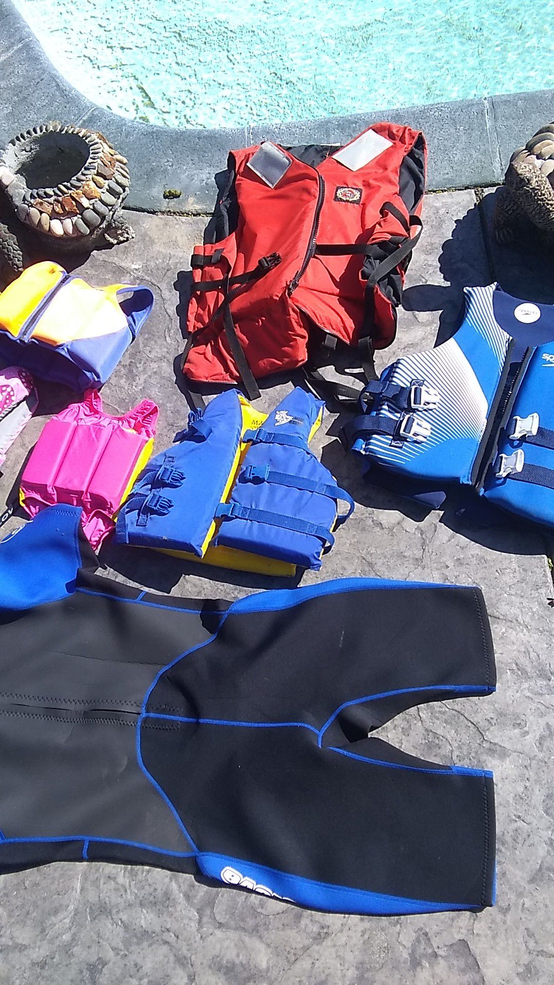 Lot of Different sizes of life jackets kids are all