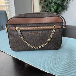Michael Kors Jet Set Large Logo Crossbody Bag in brown. 