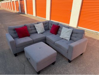 Beautiful light gray L-shaped sectional sofa with ottoman