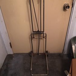 A MIGHTY MINI HAND CART WITH TWO STRETCH CORDS LITE WEIGHT AND STURDY FOLDS UP EASY USED IN GOOD CONDITION 100-POUNDS CAPCITY-$10.00