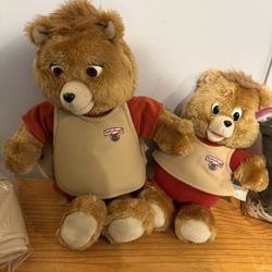 Teddy Ruxpin W/ Little Teddy, Book, Cassette, And Extra Outfits As Shown. Works BUT old Tape Player Doesn’t Work Well