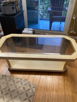 17 inches tall coffee table with glass top and wheels for $60