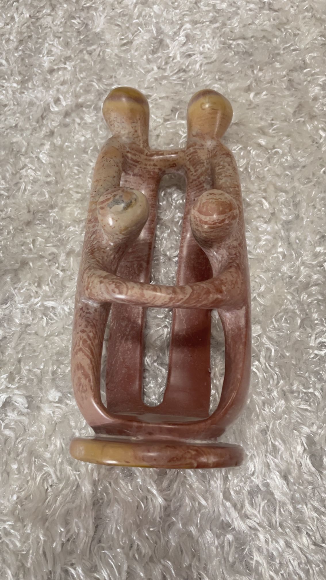 hand-carved Kisii stone sculpture of loving parents and children.