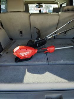 Milwaukee mower combined with a chainsaw