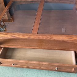 Oak coffee Table With Glass Top On Wheels.