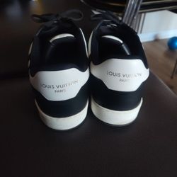 Louis Vuitton Rivoli Sneaker in the white and black Damier pattern. 