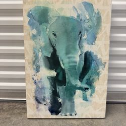 Painting on canvas with the image of an elephant, made in blue-green tones, watercolor