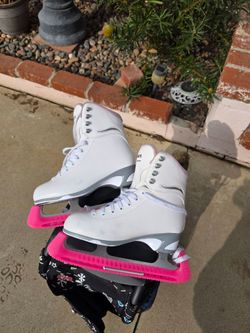 Girls ice skates and roller bag