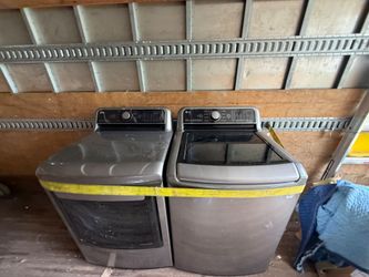 Two washers and dryer sets and stove and 3 door fridge