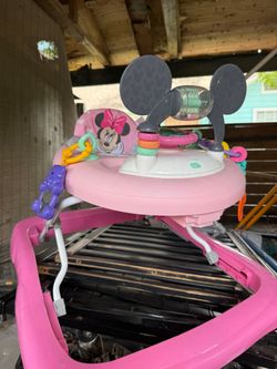Bright Starts Disney Baby Minnie Mouse themed infant walker featuring a removable toy station with lights and sounds