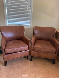Brown Faux Leather Accent Chair with Nailhead Trim. Pier one Imports.