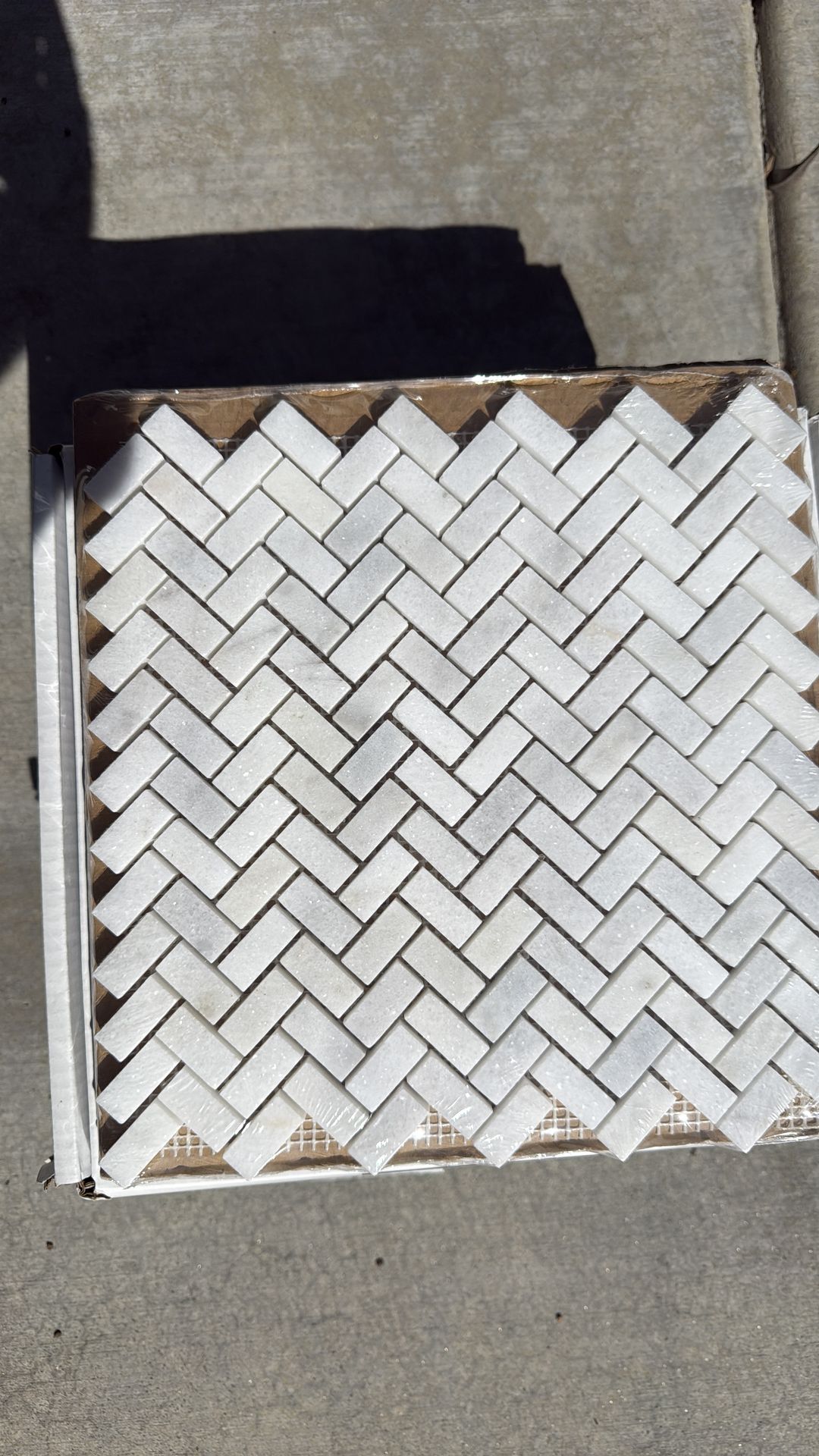 Carrara herringbone tile