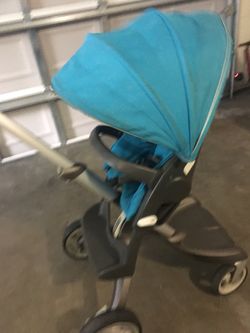 Stokee stroller baby to child grows with all in one with aqua accessories. includes bassinet, adjustable height seat with padding, diaper bag and bag