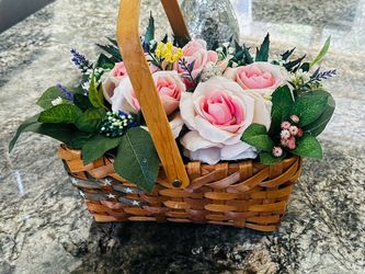 A basket with arrangements artificial flowers