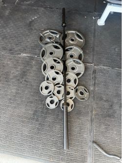 Olympic weights 255lbs total plus 7ft 45lbs bar