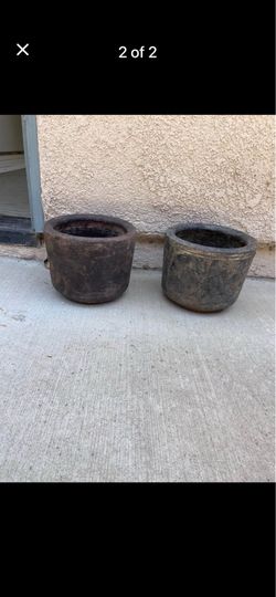 Three terra-cotta/ceramic planters.