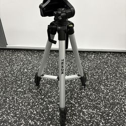 The Trikon brand tripod shown in the image is typically an affordable, model.