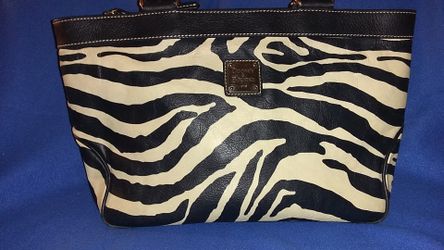 This is a zebra pinted leather purse it is a pretty nice little bag
