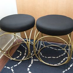 Pair of gold and black stools

