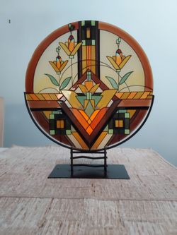 Glass plate in stand with candle