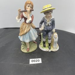 Two vintage figurines the girl says Lipton Japan on her bottom and a sticker 