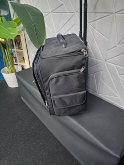 Black rolling suitcase for storing crafts