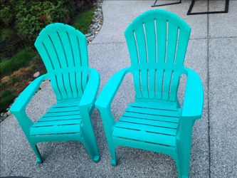 2 turquoise plastic chairs