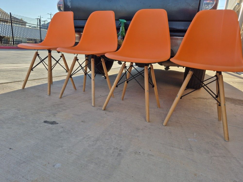 4 Orange Plastic With Wooden Legs Dining Chairs