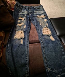 Heavily Distressed Blue Denim Jeans