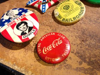 Many vintage advertising and political pins