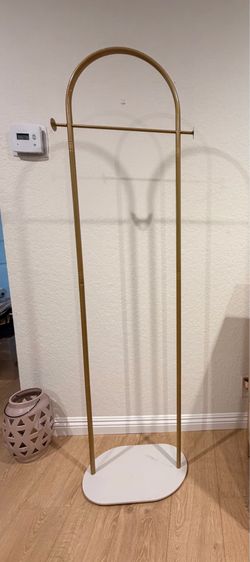 Gold arched clothing rack with marble base