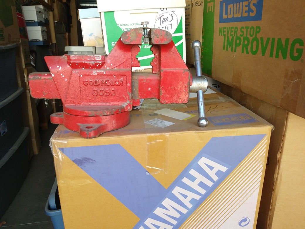 Columbia 3050 Bench Vise. Used In Home Workshop. Red Color. The Length Is 14 1/2 Inchs Long With A 9 Inch. Round Base