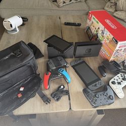 2 Nintendo Switch/ Mario Soccer, Smash Bros/ Live Mario Kart/ Bag Holder And Extra Controller 