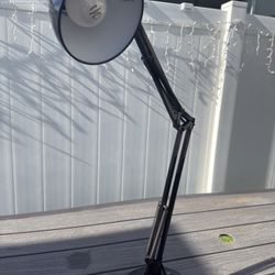 Selling black articulated desk lamp.